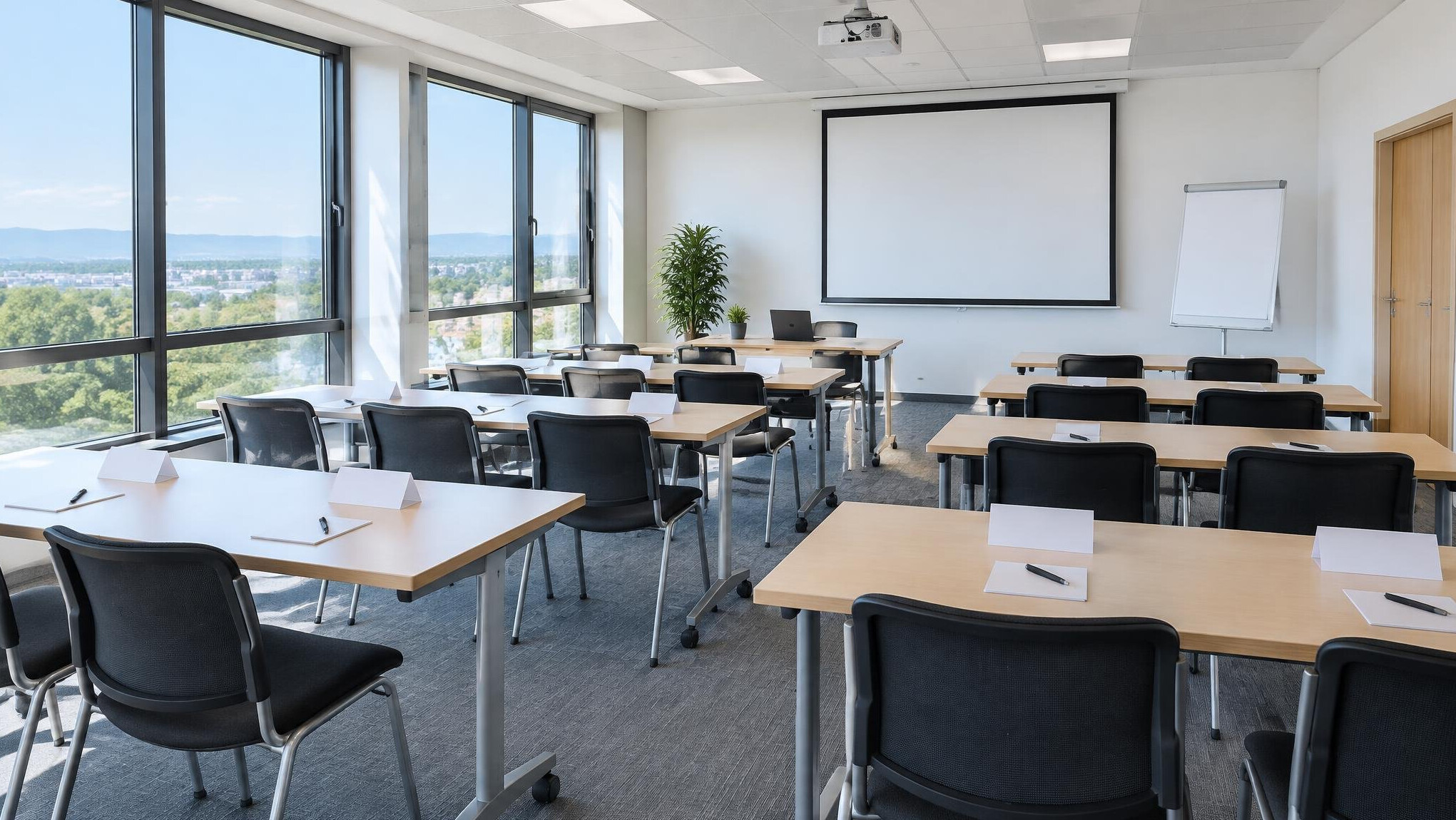 Empty bright classroom with tables, chairs and projector prepared for a course